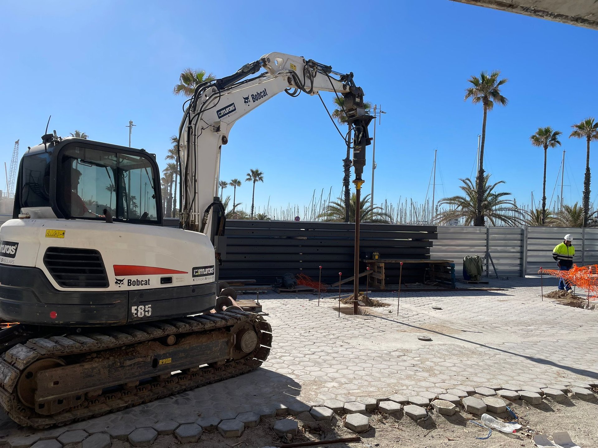 Helical pile installation with excavator-mounted drive head