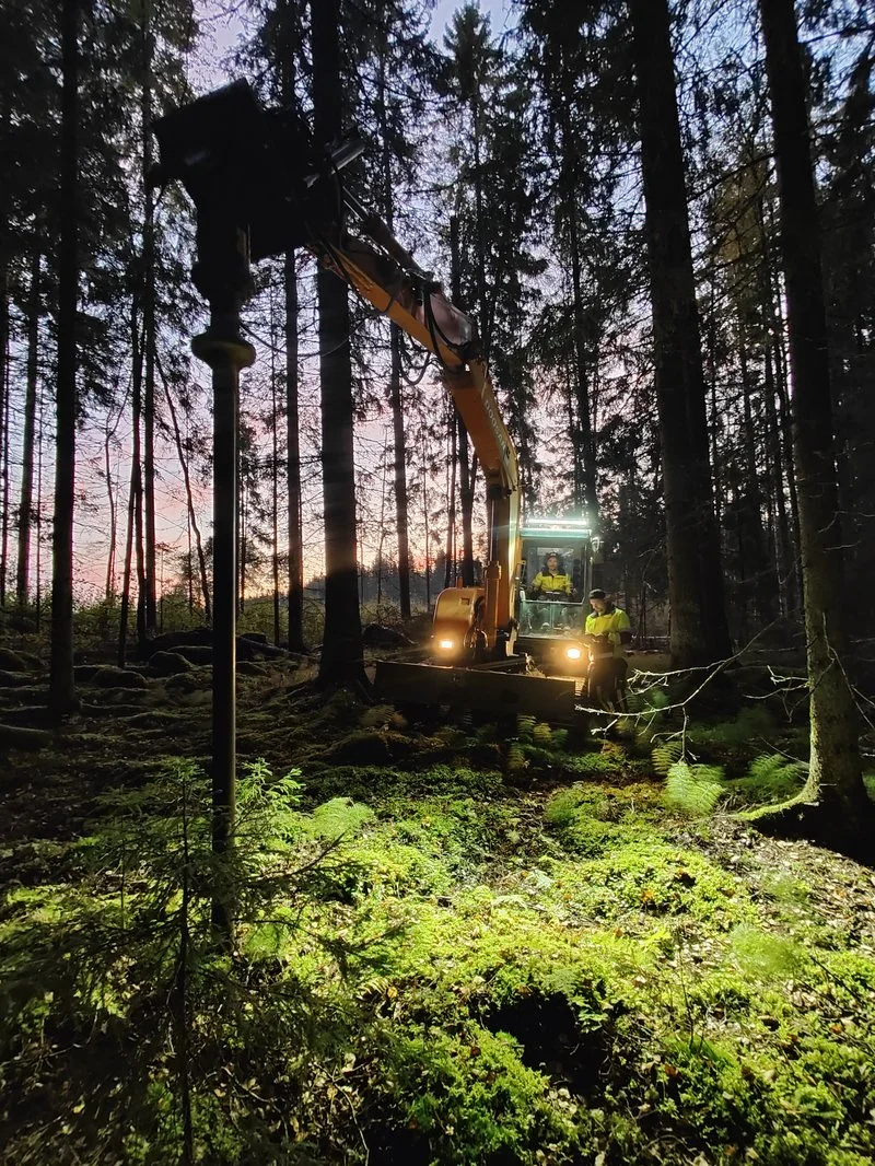 Screw pile installation in forest