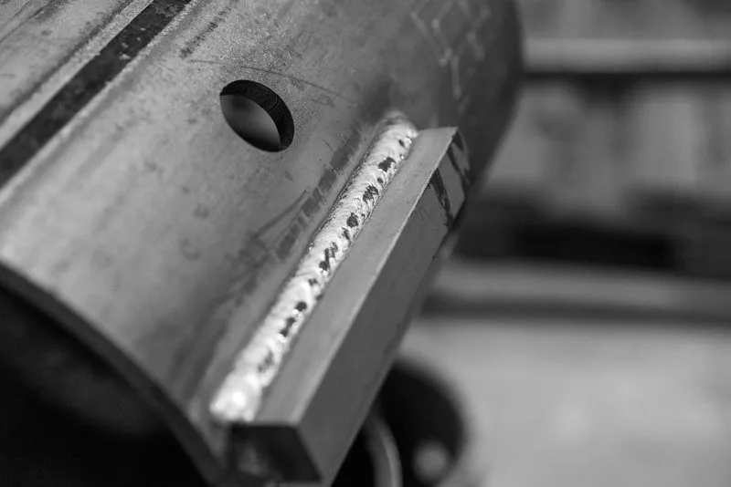 Close-up of a welded drive lug on a helical pile shaft
