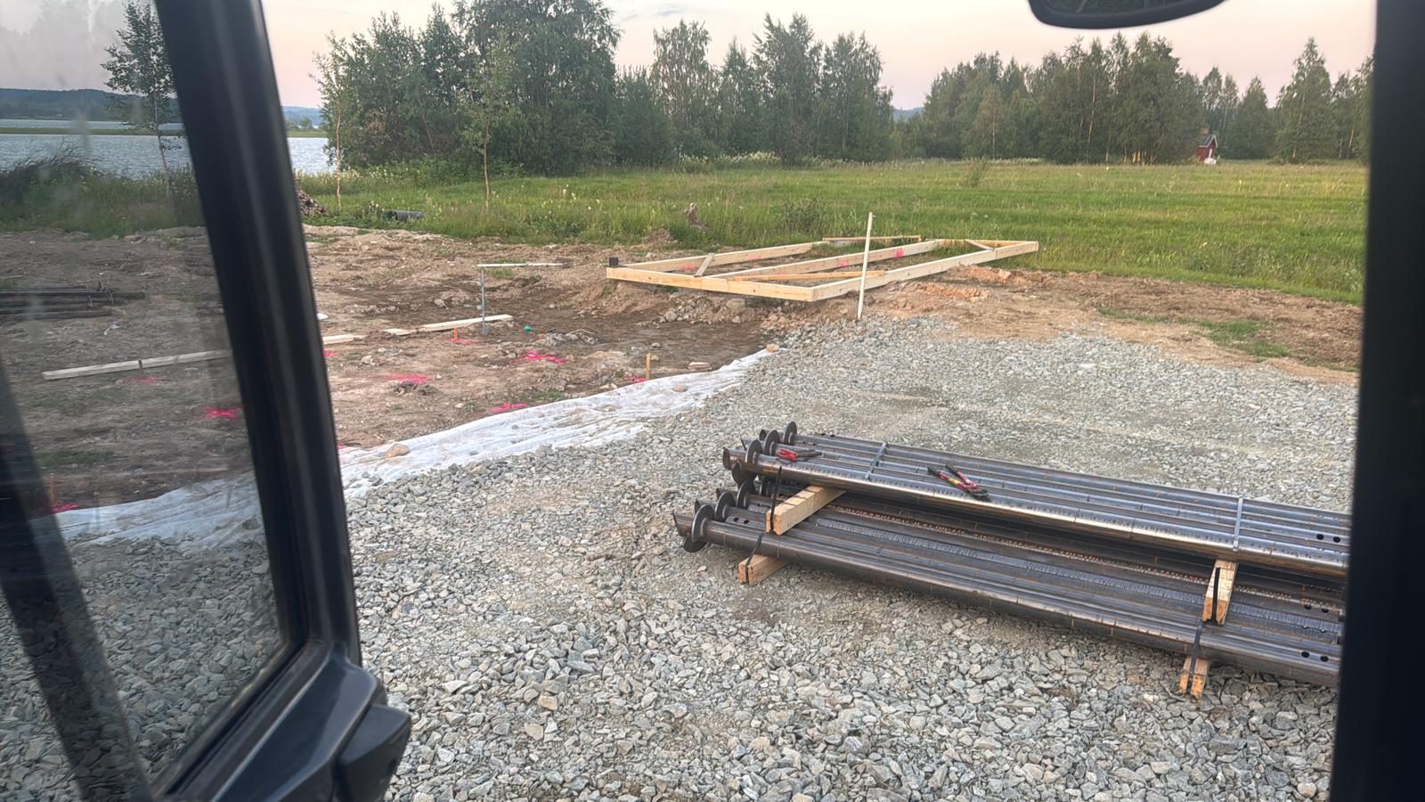 Screw piles ready for residential foundation installation on lakeside plot