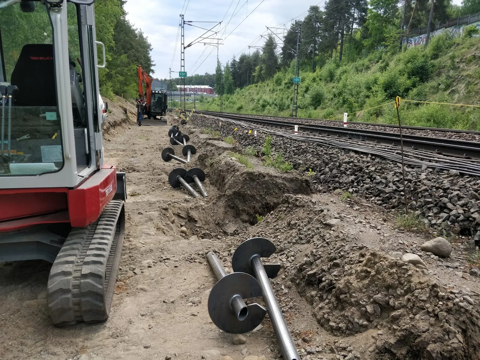 Railway noise wall screw pile foundations