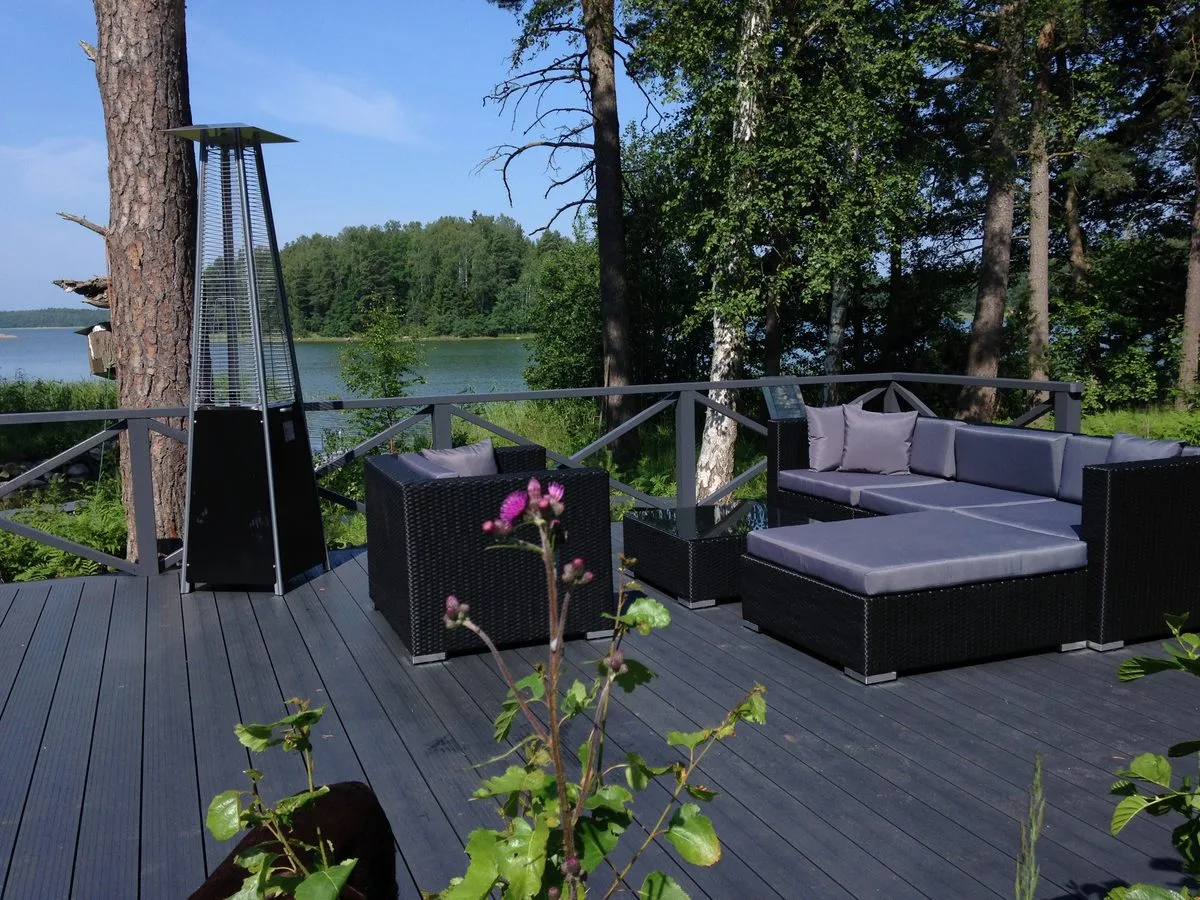 Lakeside lounge deck with outdoor furniture on screw pile foundation