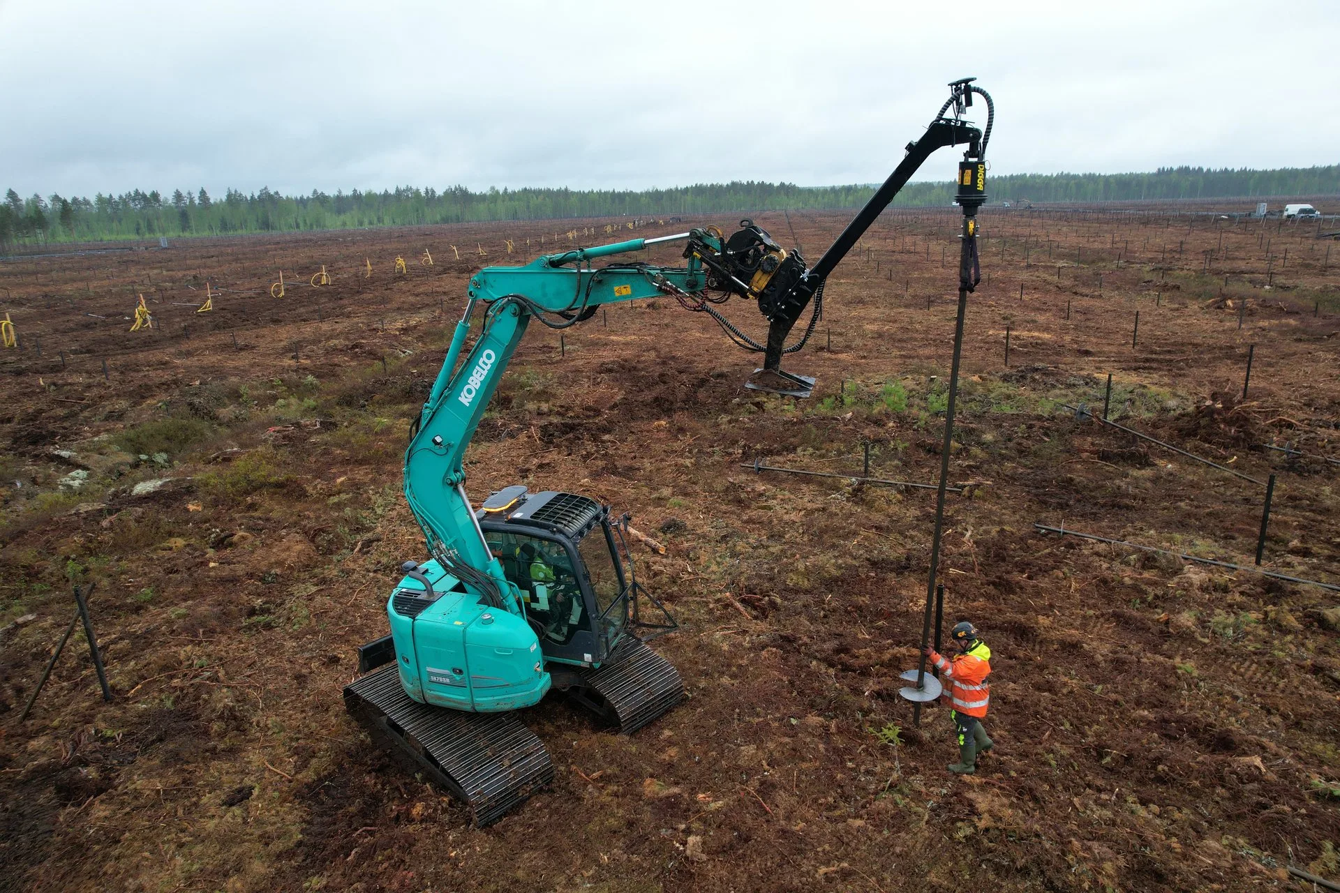 Helicasol excavator installing screw piles at solar park