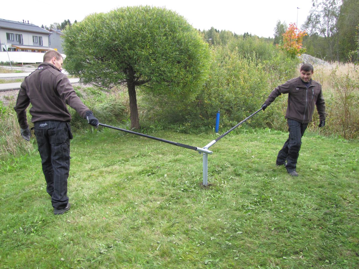 Two people installing a HELIX screw pile by hand - engineered alternative to ground screws