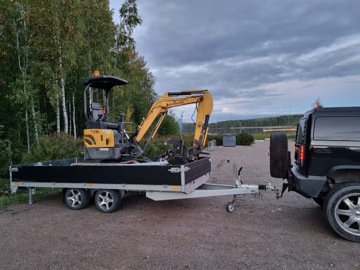 Mini excavator with screw pile equipment on trailer for rental